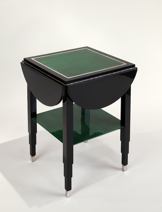 Drop-leaf table by Marcel Coard, c. 1930. Black-lacquered wood and green tinted parchment, silver bronze feet.​