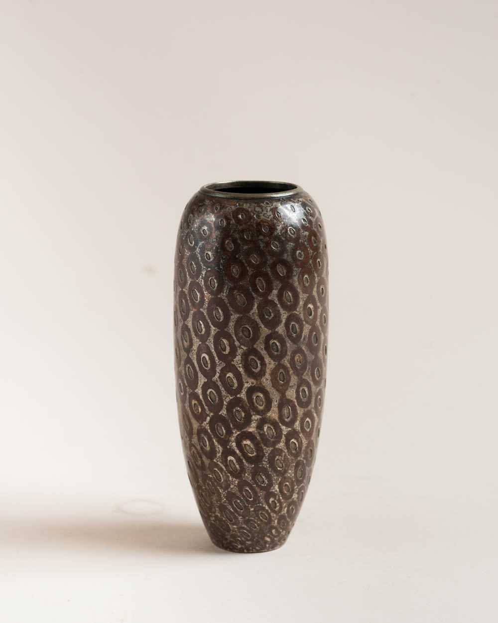 Copper dinanderie vase​ by Jean Dunand, c. 1925. Geometric​ patterns​ and red lacquer.