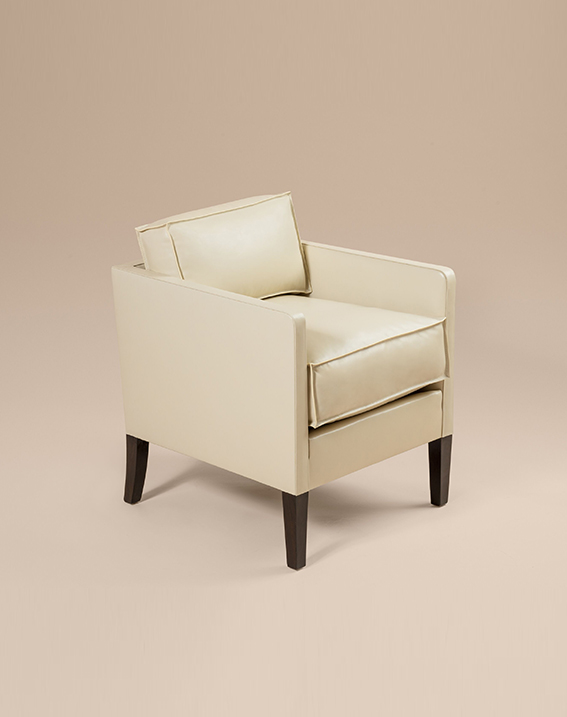 Cubic armchair​ with white leather and ebony veneered feet and by Jean-Michel Frank, c. 1928.