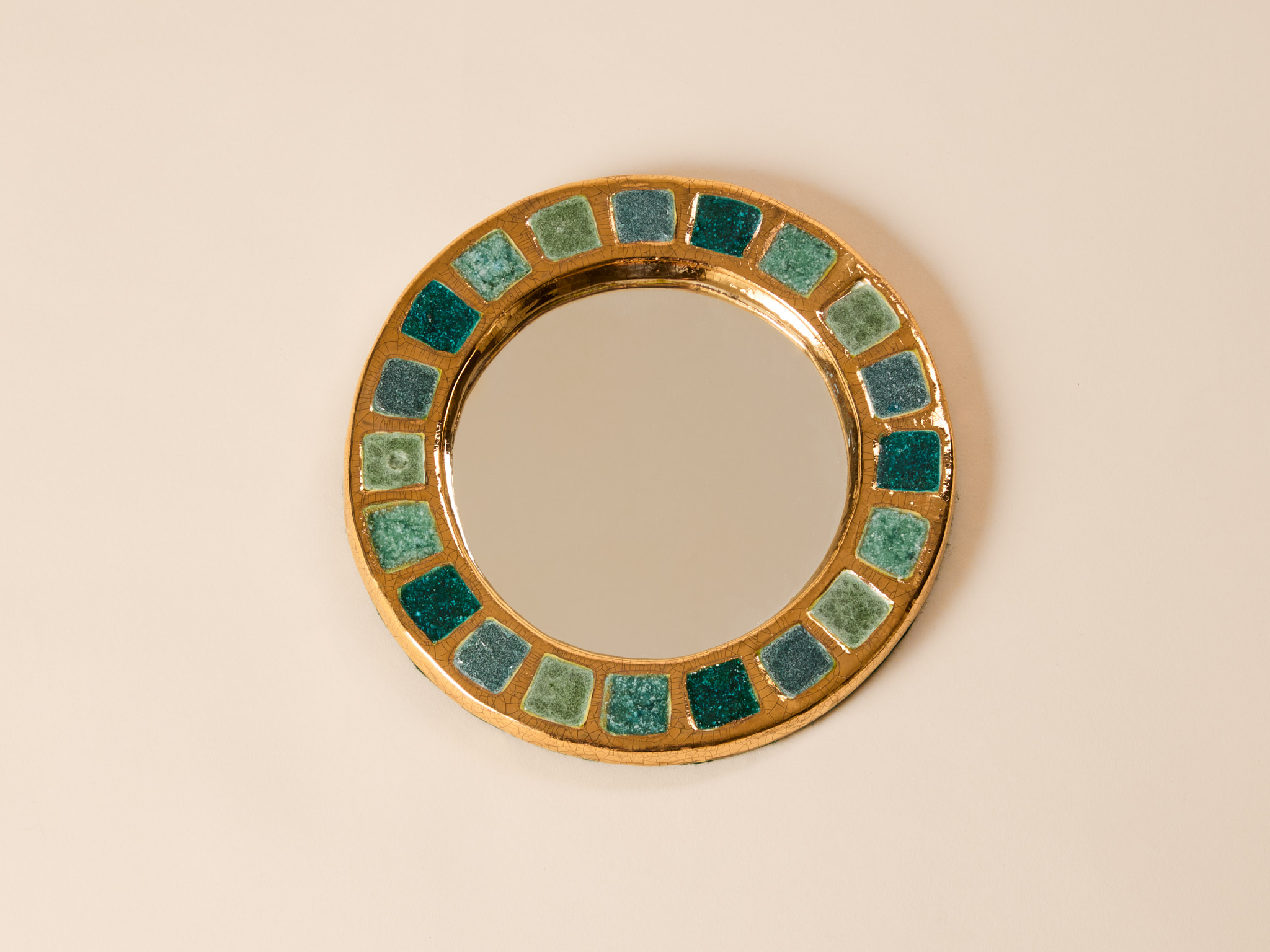 ‘Engrenage’, round mirror​ by Mithé Espelt​, c. 1950, crystallized green glass and crackled gold​​.