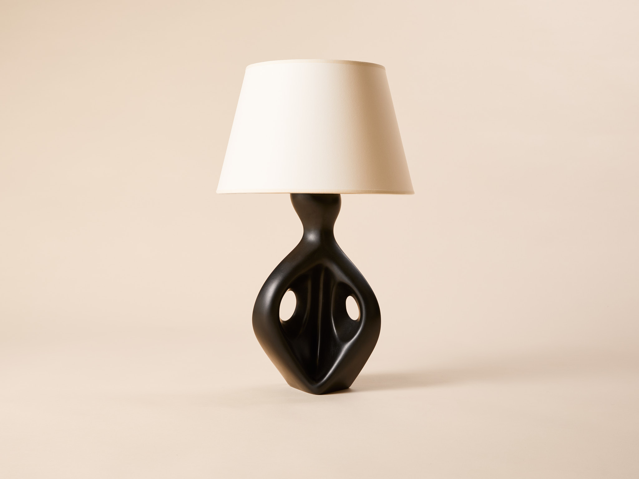 Freeform lamp in molded black glazed ceramic, c. 1950.