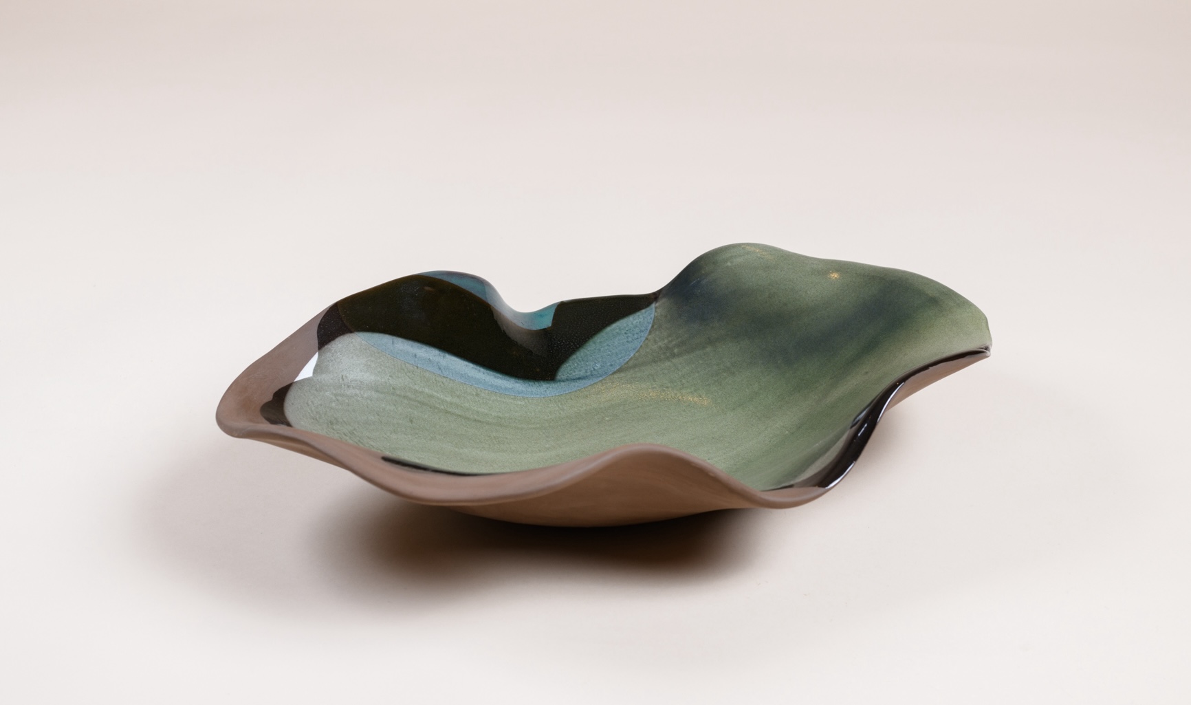 Large “Oyster” bowl by Claire De Lavallée, partially glazed brown clay and white engobe.