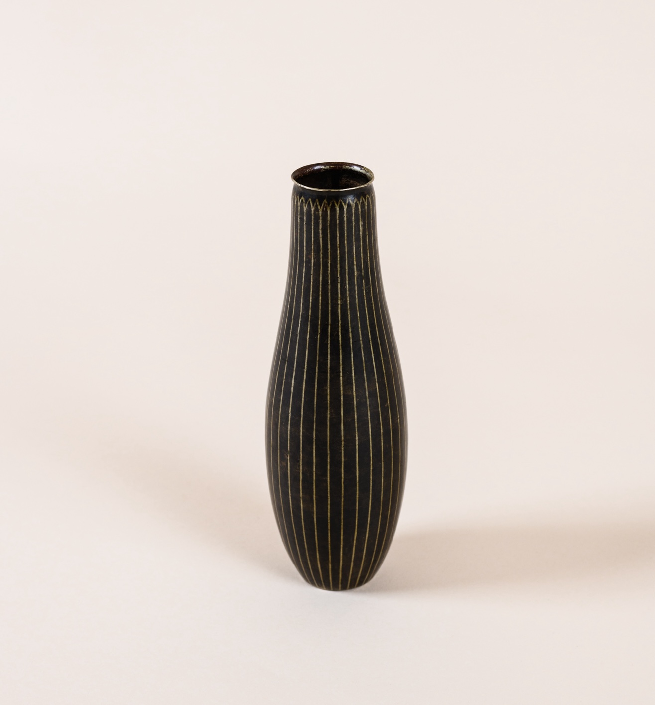 Ovoid vase by Jean Dunand, c. 1925. Copper dinanderie with silver-inlaid stripes.