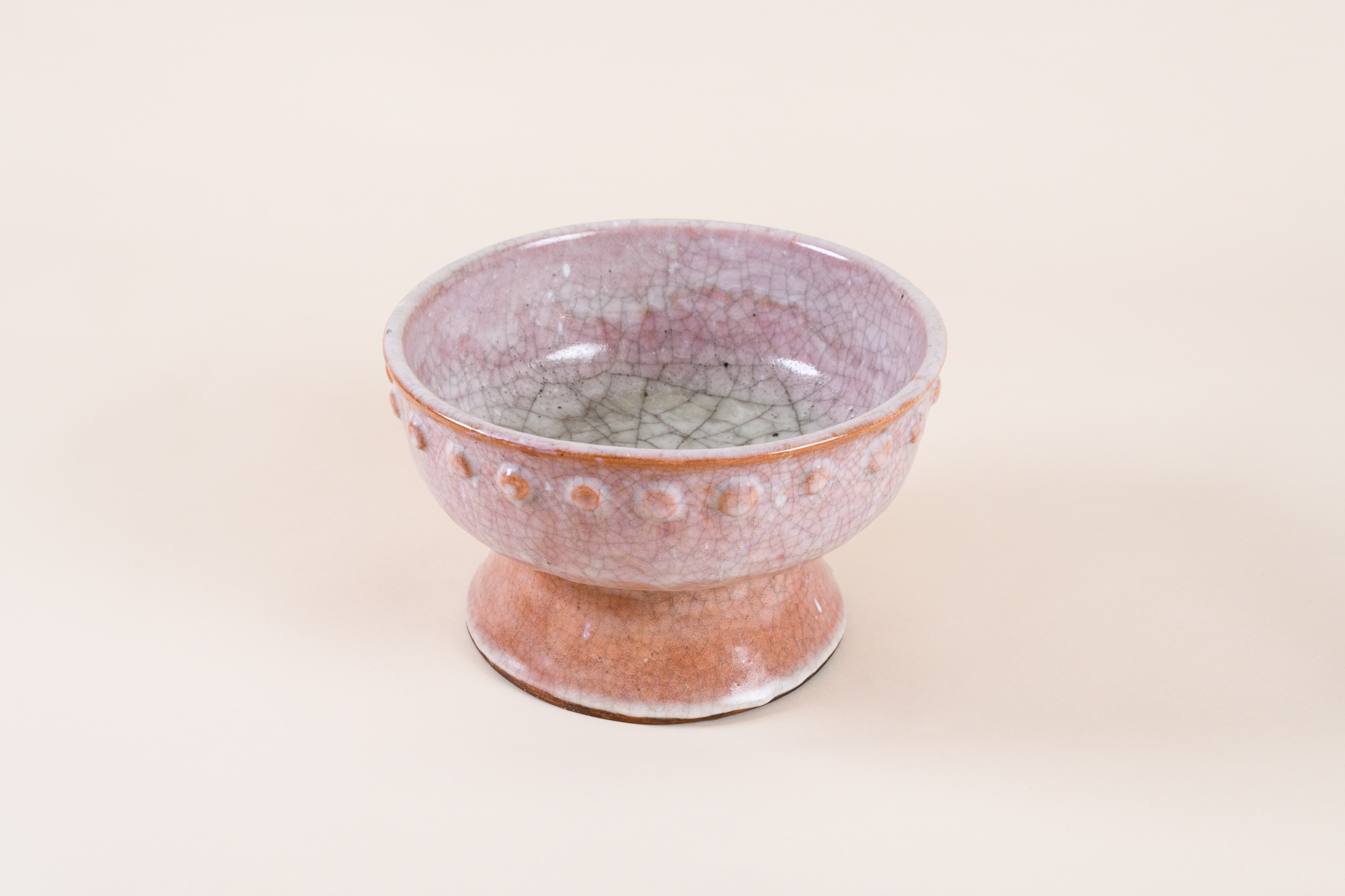 Pedestal cup​ by Jacques Lenoble, c. 1935 in glazed and crackled light pink terracotta.