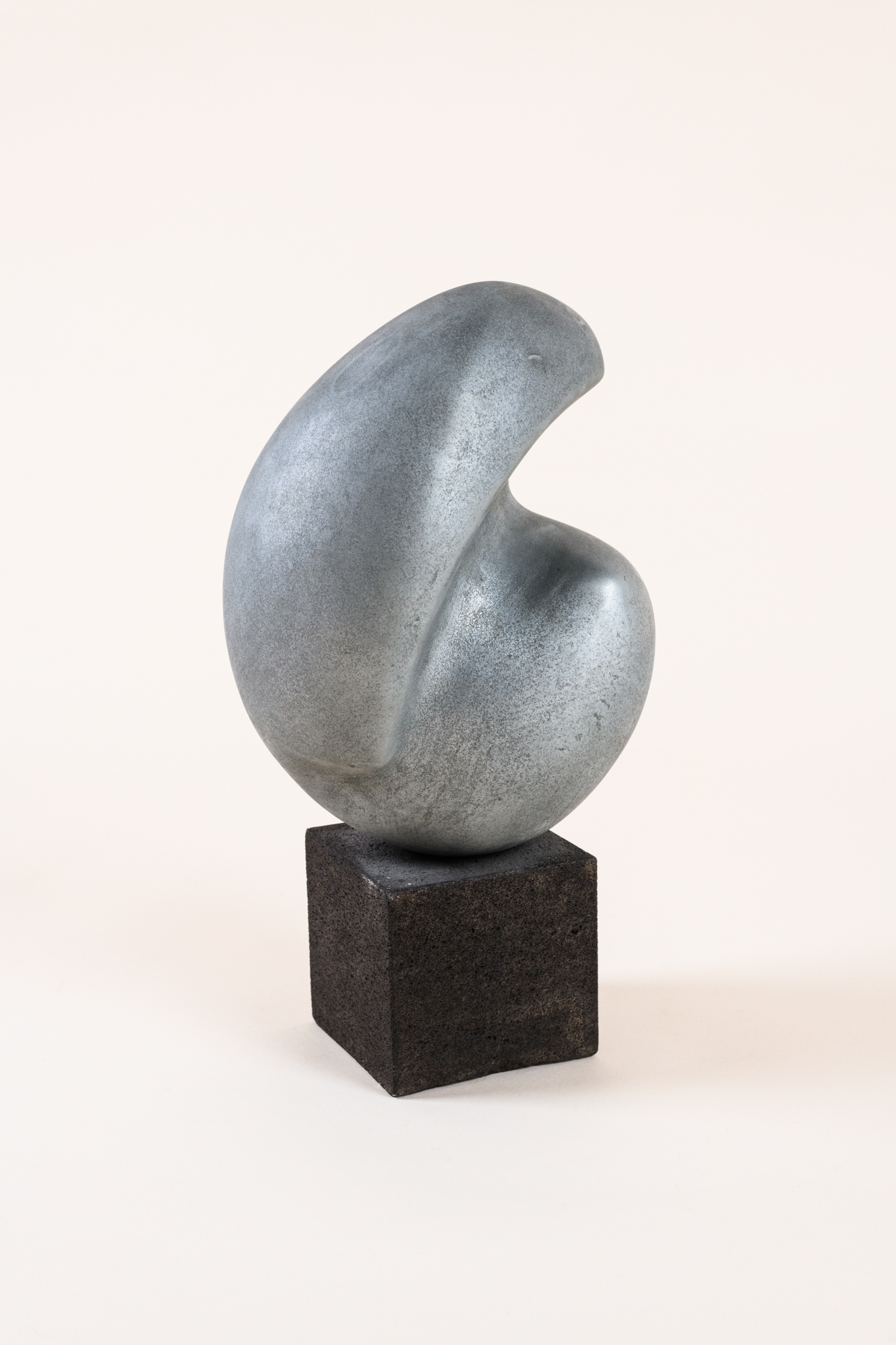 Abstract sculpture​ by Michell Hartmann, 1973, sprayed lead on ceramic on a ​wooden base.