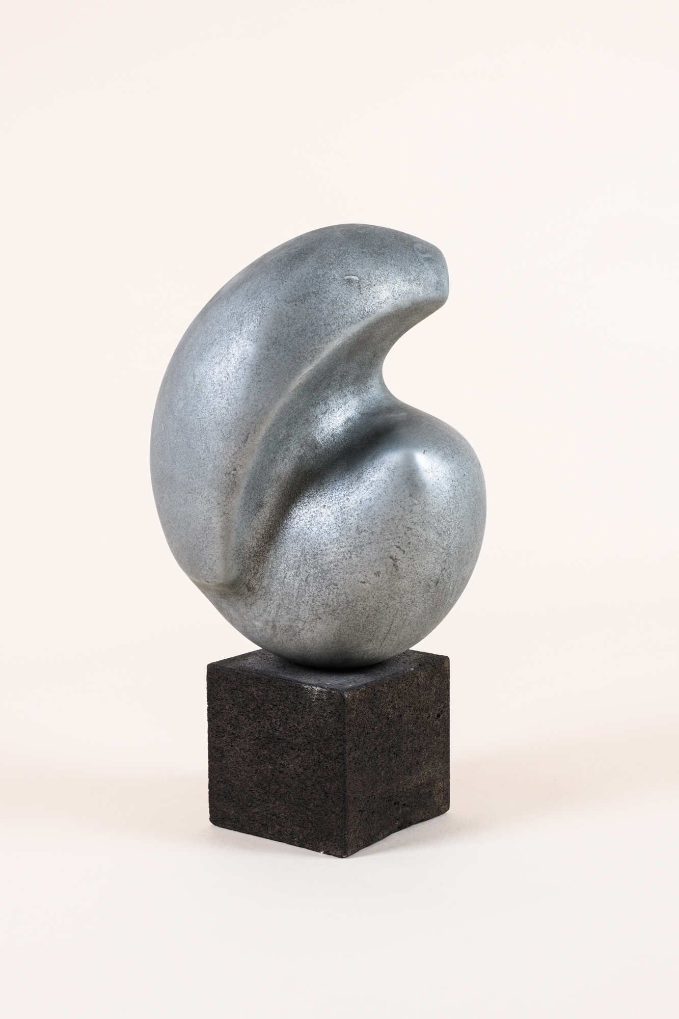 Abstract sculpture​ by Michell Hartmann, 1973, sprayed lead on ceramic on a ​wooden base.