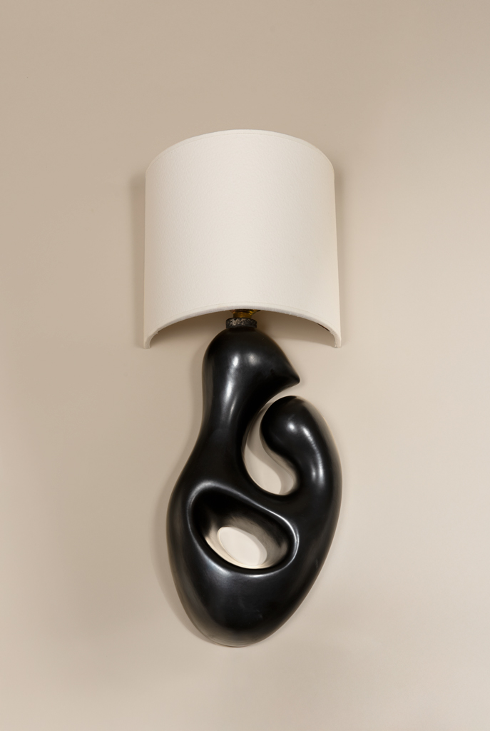 Freeform sconce in molded black glazed ceramic, c. 1950.