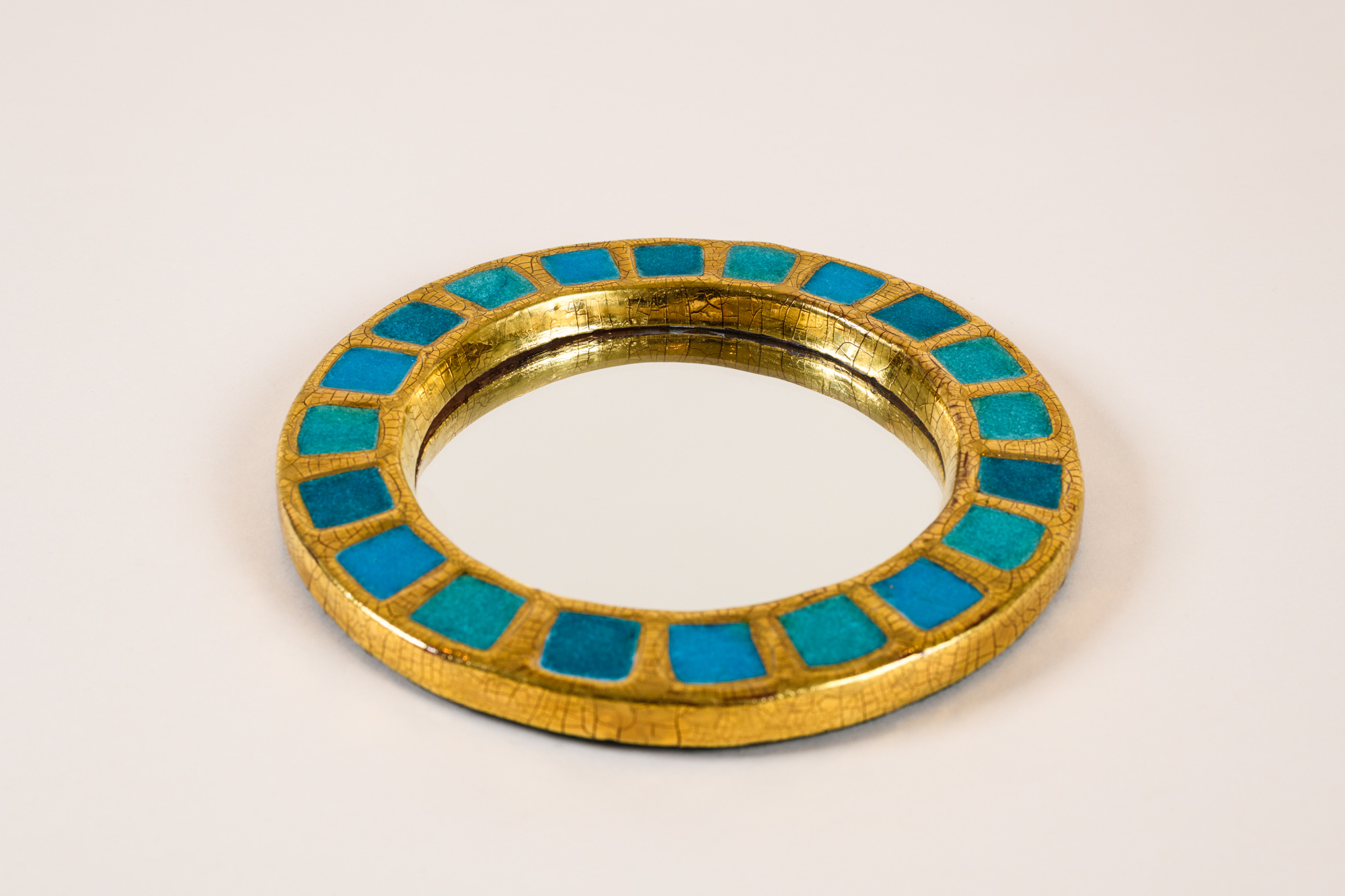 “Engrenage” round mirror​ by Mithé Espelt​, c.1950, crystallized blue glass and crackled gold​​.